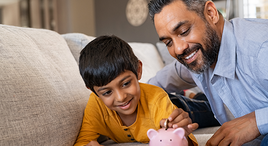 Saving1 Dad and son with piggy bank