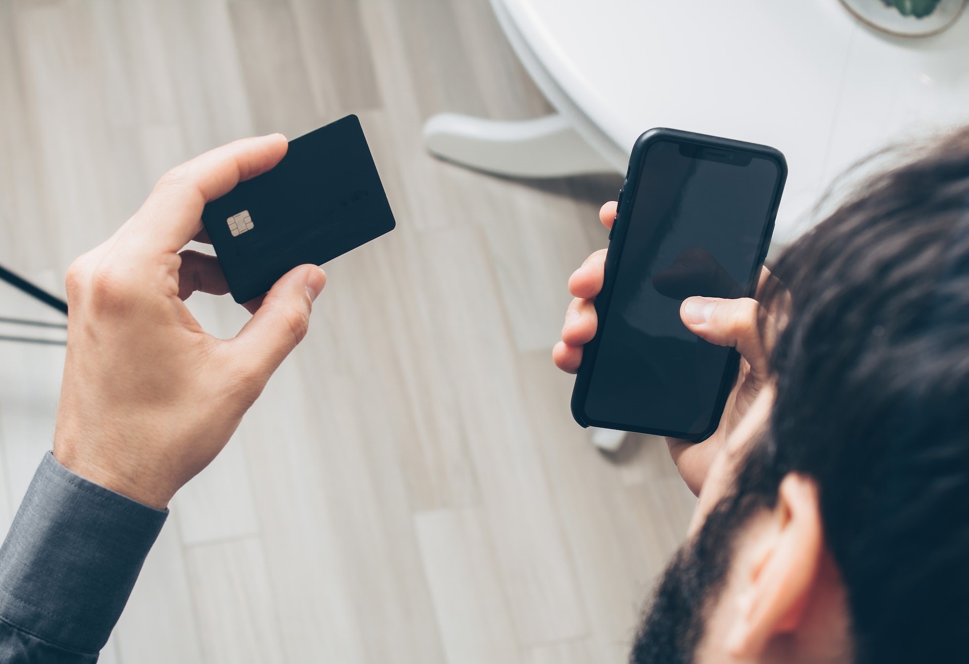 Man Holding Phone And Banking Card Full Size Man Holding Phone And Banking Card Full Size