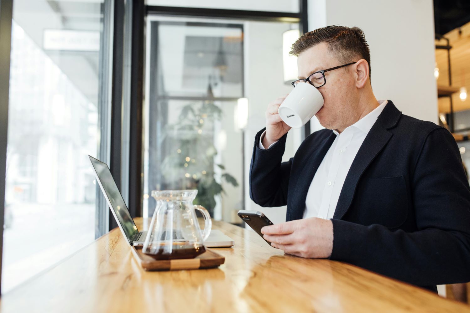 Man Drinking Coffee In Front Of Laptop Man Drinking Coffee In Front Of Laptop