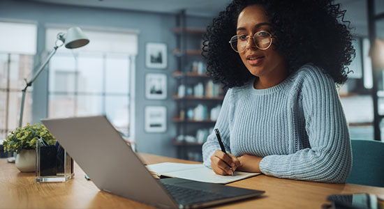 Woman Managing Line Of Credit Through Online Banking Woman Managing Line Of Credit Through Online Banking