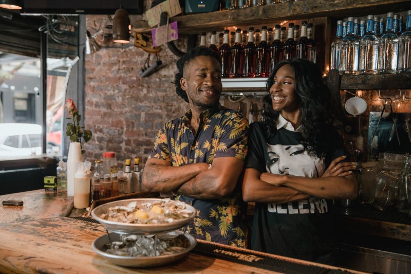 Restaurant Owners Posing Behind Bar